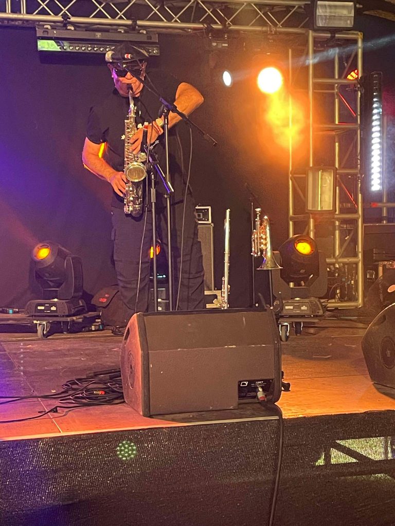 Tony Wrafter playing Saxophone at Gary Clail gig, Beautiful Days 2024
